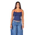 A woman modeling a navy blue ribbed tank top with red trim on the straps and neckline, paired with blue jeans, against a solid white background.